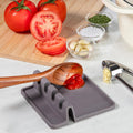 Silicone spoon holder with a tray designed to catch cooking drips