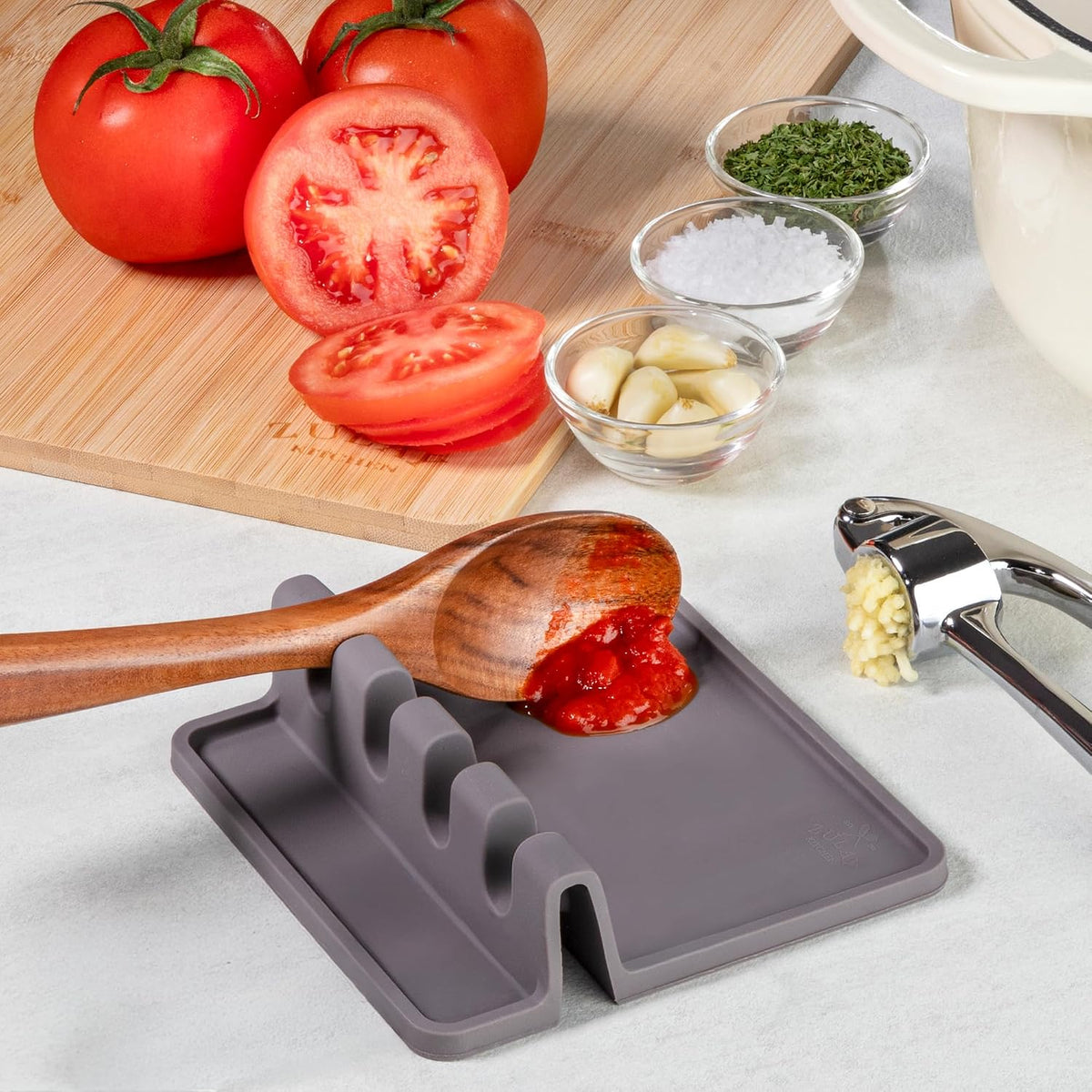 Silicone spoon holder with a tray designed to catch cooking drips