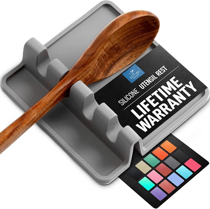 Gray silicone utensil rest with raised edges and a drip-catching base