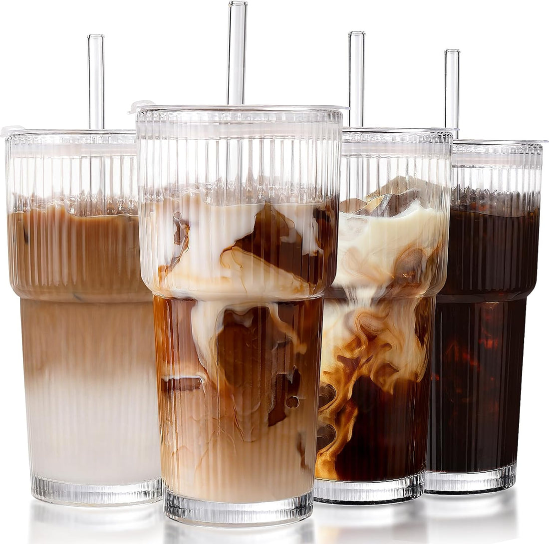 Set of four ribbed glass cups with lids and straws