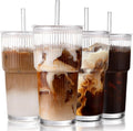 Set of four ribbed glass cups with lids and straws