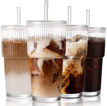 Set of four ribbed glass cups with lids and straws